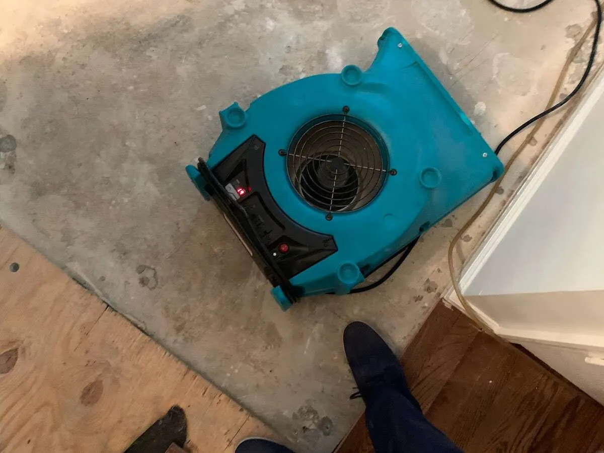 Air mover drying subfloor during Commercial Water Damage Restoration in Finneytown